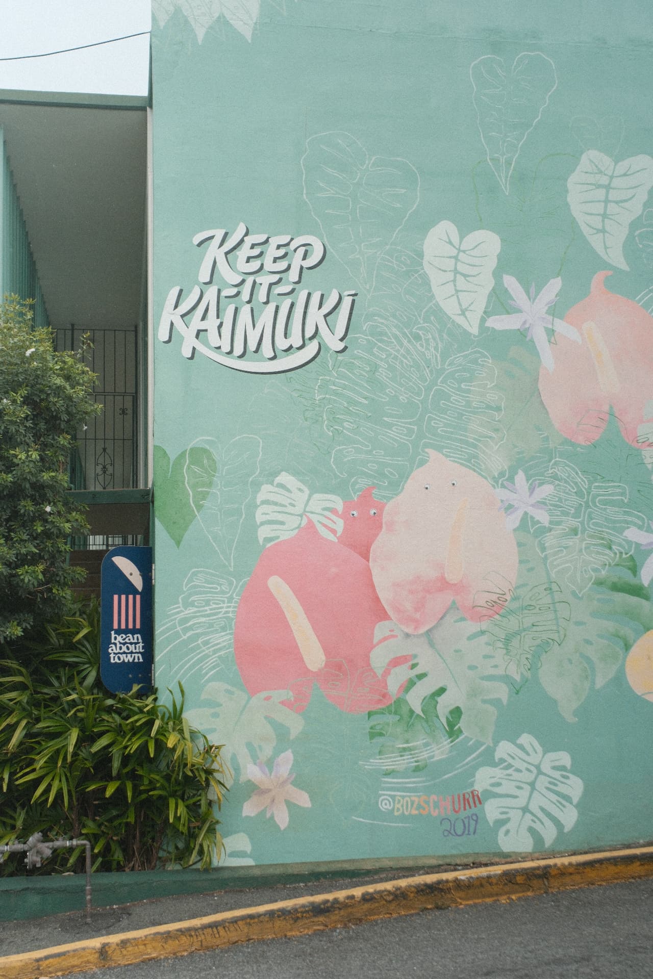 Colorful Keep It Kaimuki neighborhood mural on a building wall