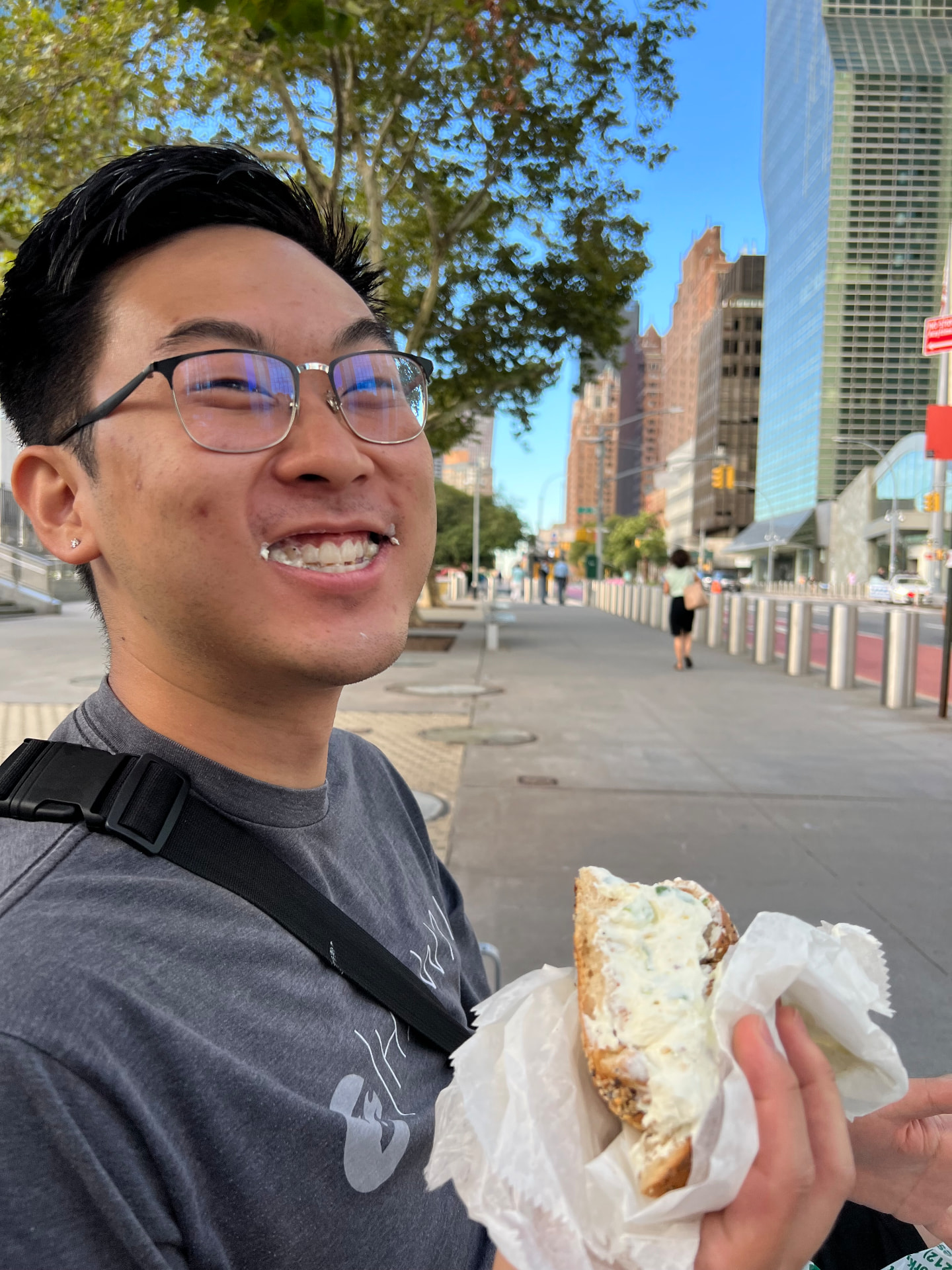 Guide eating a fresh bagel with scallion cream cheese