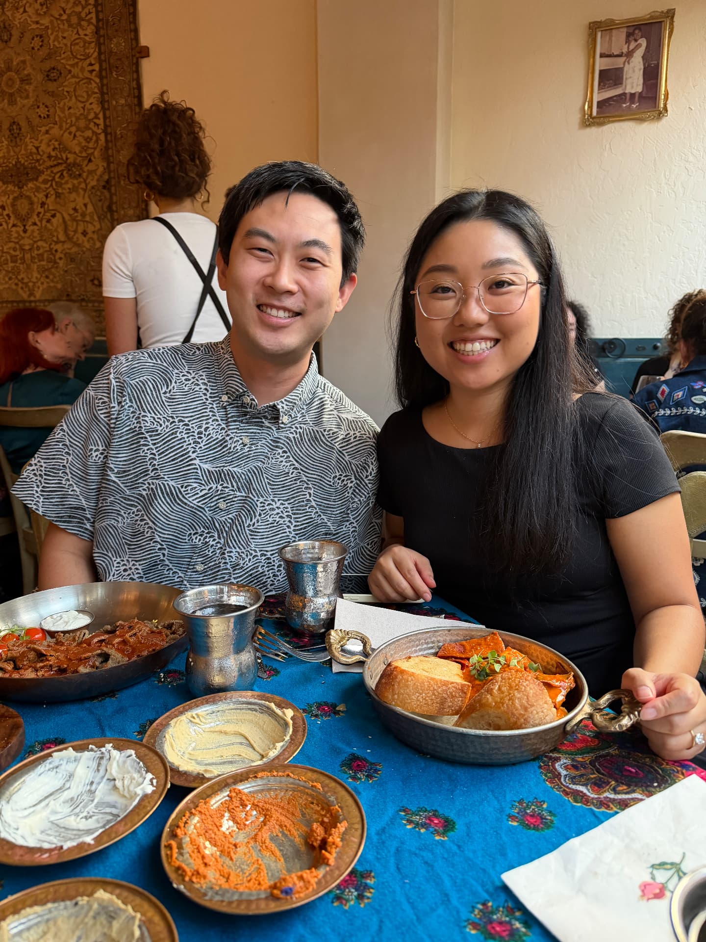 Guide and his fiancée sharing a table full of shared plates