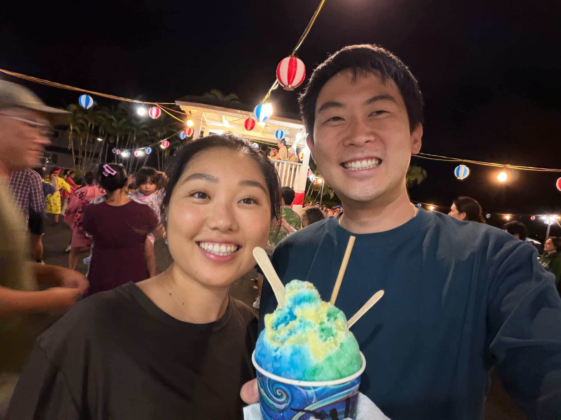 Guide and his fiancée with rainbow shave ice at a Hawaii bon dance